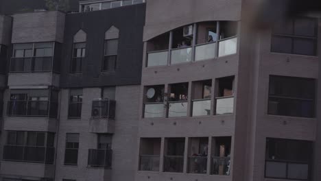 people on balconies of apartment buildings