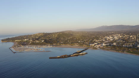 santa barbara california drone angle looking toward harbor town with pier ocean waves and boats 4k prores