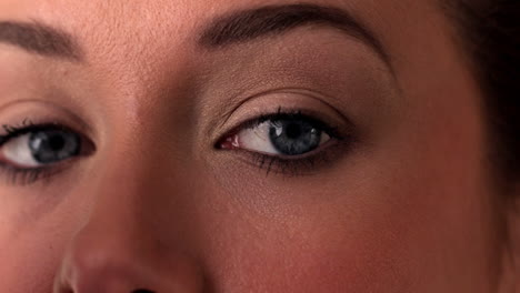 close up of woman applying eye shadow to eye