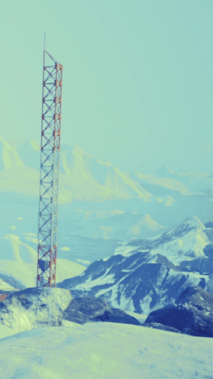 Telecommunication tower stands tall on snowy mountain landscape in cold weather