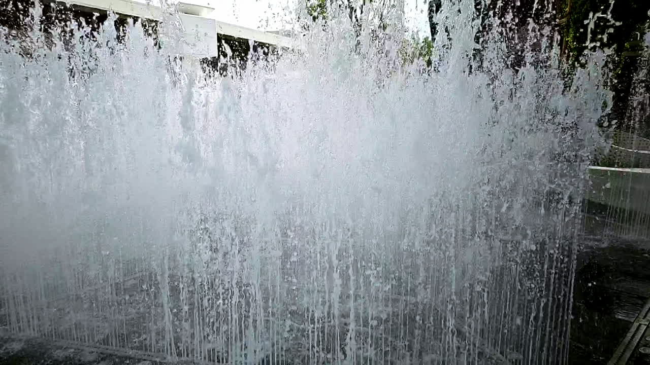 Slow motion of a water fountain situated in the middle of a community mall in Bangkok, Thailand
