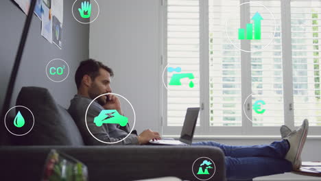 animación de iconos de conceptos de energía verde contra un hombre caucásico tomando un teléfono inteligente en la oficina