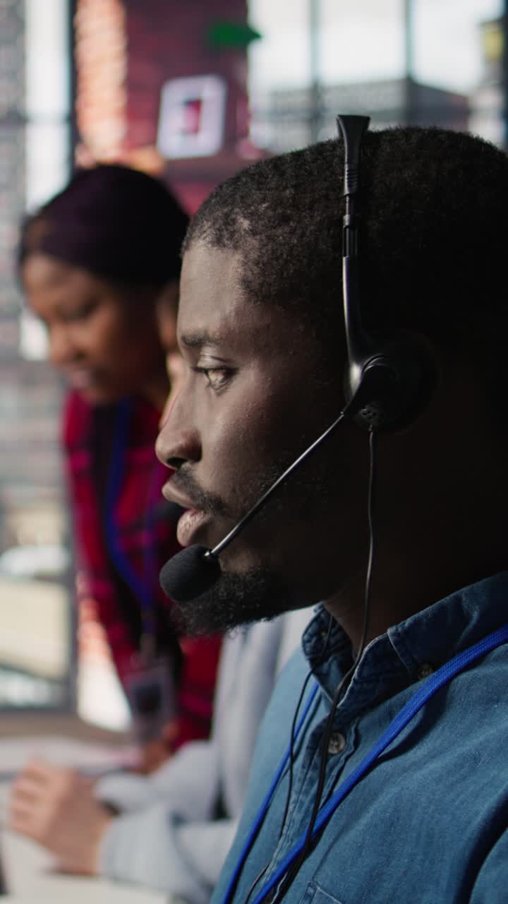Vertical video Diverse customer center workers assisting clients with installing software
