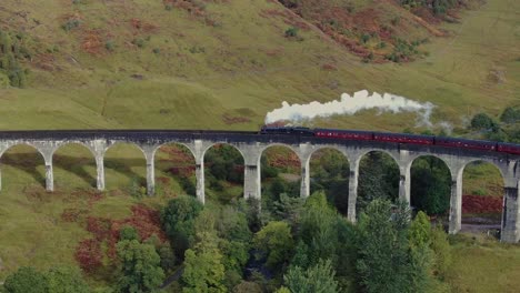 the famous harry potter train travelling over the glenfinnan viaduct in scotland