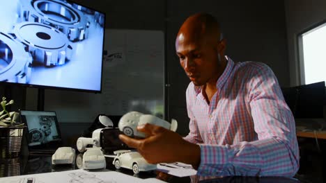 male executive examining a car model 4k