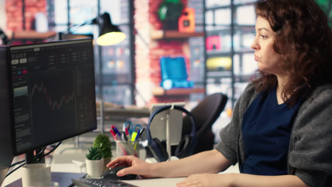 Financial investor works on PC analyzing stock market trends