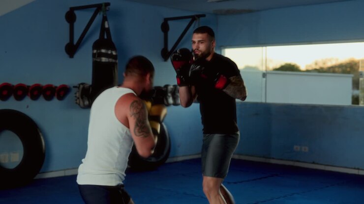 Two men sparring in a boxing gym