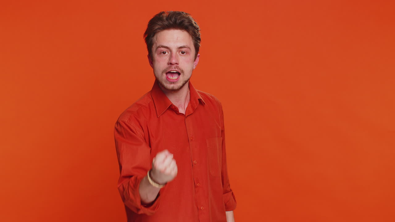 Aggressive angry caucasian man trying to fight at camera shaking fist boxing punishment threaten