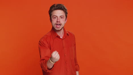 aggressive angry caucasian man trying to fight at camera shaking fist boxing punishment threaten