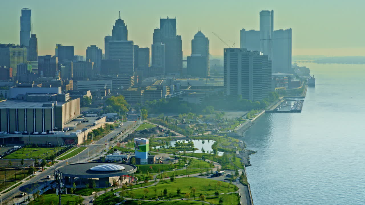 Dramatic drone footage over Detroit River, showing freighter cutting across the urban waterfront