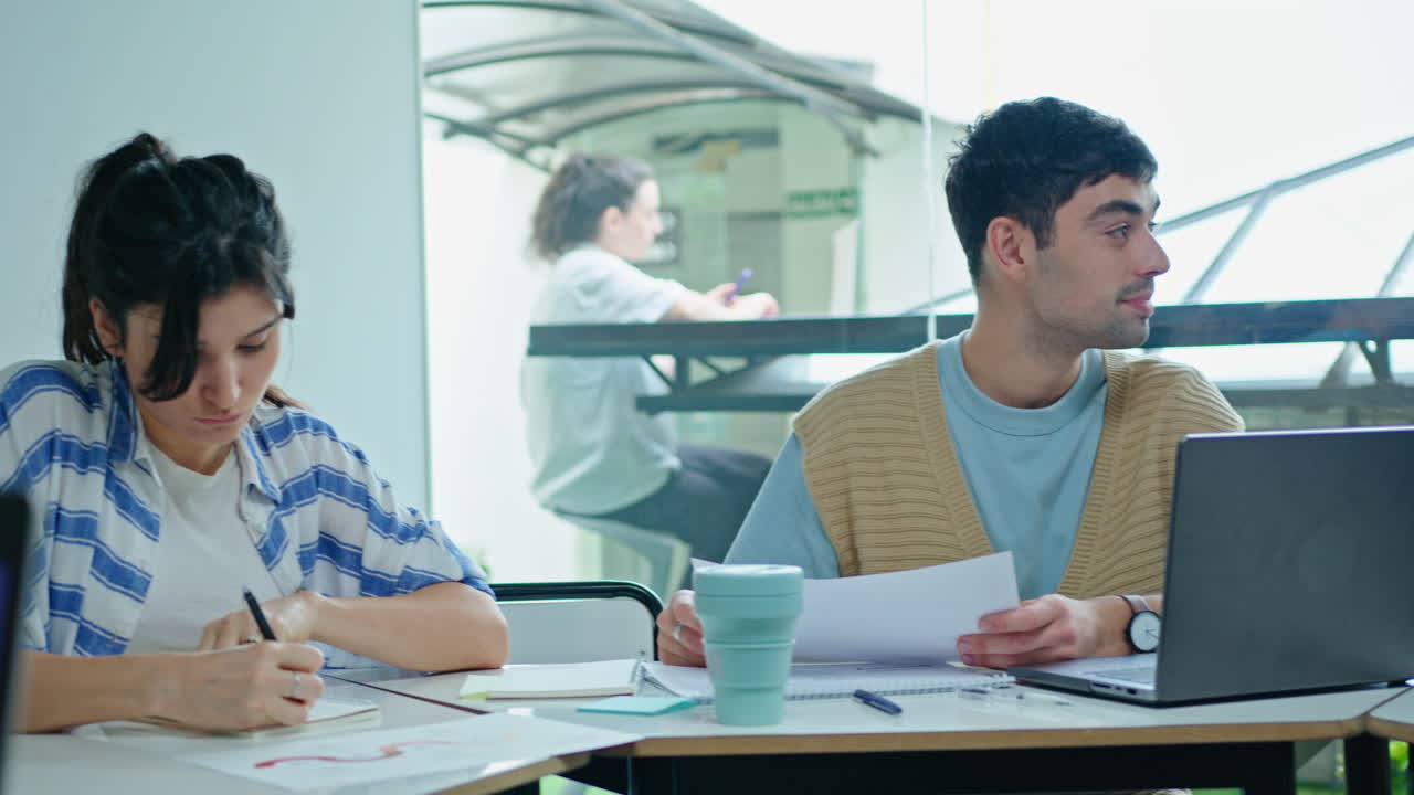 Young Woman Discussing Business Report with Coworker in the Office
