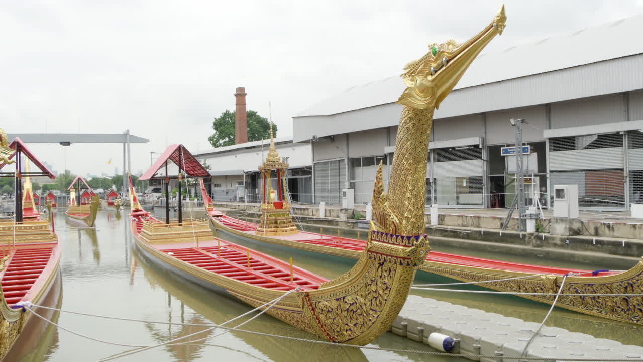 Ornate display of The Royal Barge Suphannahong, showing the intricate details of each golden boat, displayed at the Thai Royal Barge Museum in Bangkok, Thailand.