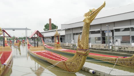 ornate display of the royal barge suphannahong, showing the intricate details of each golden boat, displayed at the thai royal barge museum in bangkok, thailand.