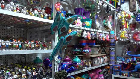 slow motion panning shot of gifts for sale at a tourist gift shop in mexico