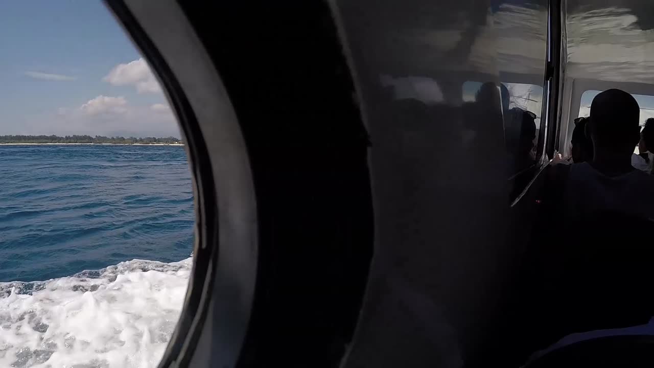 Boat ride with sea, sky, island, clouds and people