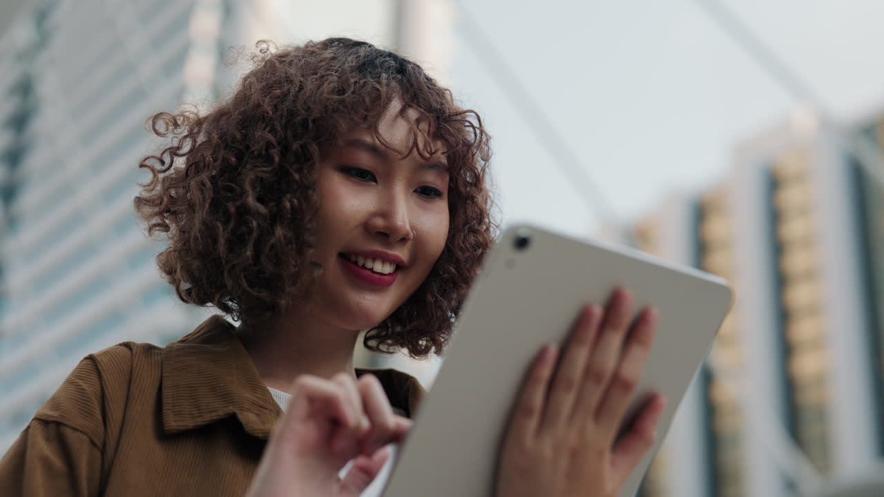 Woman using tablet in city