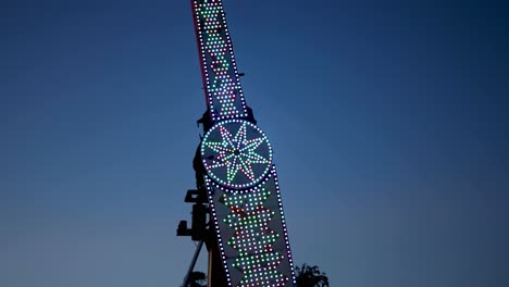 colorful amusement ride swinging against sky