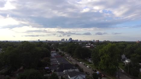 rising shot over neighborhood to downtown skyline