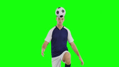 Video-of-caucasian-male-soccer-player-kicking-ball-on-green-screen-background