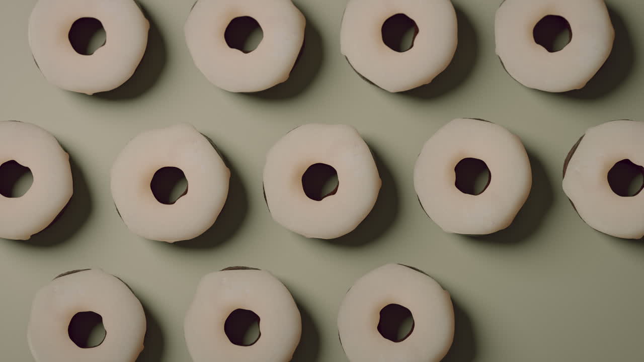 White glaze donuts on a light green background