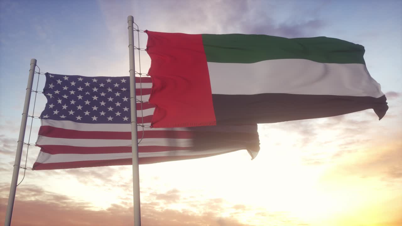 United Arab Emirates and United States flag on flagpole. UAE and USA waving flag in wind. UAE and United States diplomatic concept