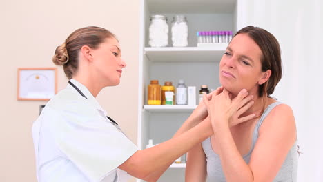 médico chequeando las glándulas de un paciente