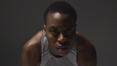 close up studio portrait of young woman wearing gym fitness clothing for exercise