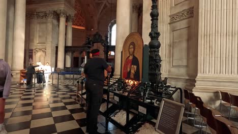 visitors light candles in a sacred space