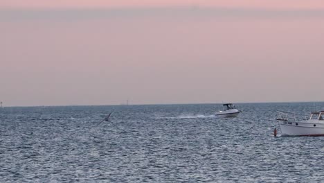 a boat moves across the ocean at sunset