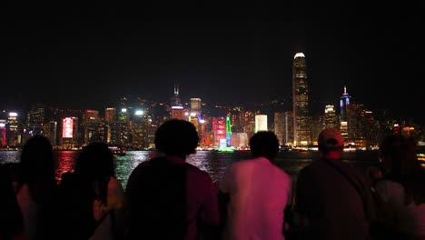 people enjoying hong kong's vibrant night skyline