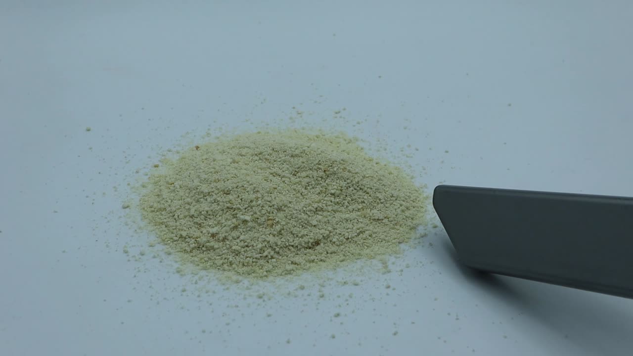 Vacuum cleaner with crumbs on white table surface
