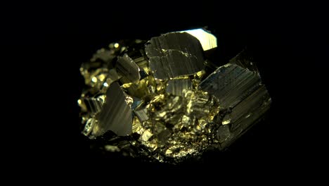 seamlessly rotating a golden mineral (pyrite) in front of black background