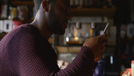 man using mobile phone in cafe 4k