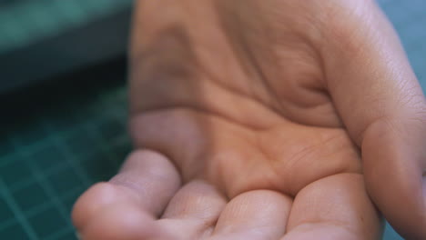 professional designer pours eyelet details on hand closeup