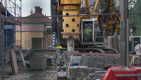 a large yellow drilling rig at a construction site