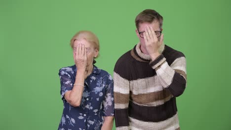 grandmother and grandson looking frustrated while covering face together