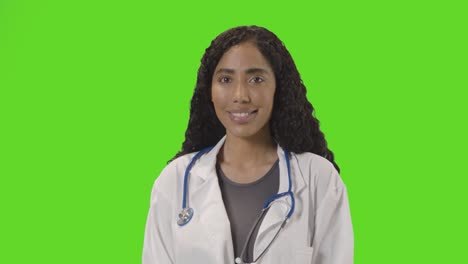 portrait of female doctor in white lab coat with stethoscope against green screen 3