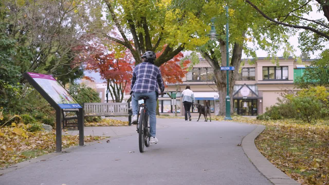 A cyclist cycling in a park in Port Coquitlam.