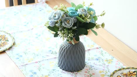 light blue flowers in gray vase