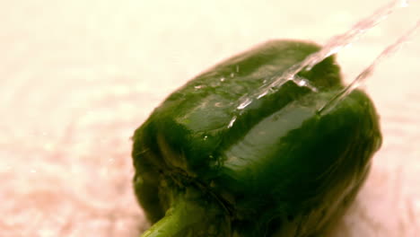 water pouring on green pepper