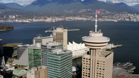 harbour centre skyscraper near canada place with vancouver harbour in vancouver, cinematic drone tilt up reveal