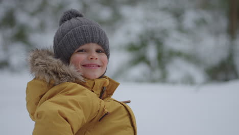 Retrato-De-Un-Lindo-Niño-Sonriente-De-3-A-4-Años-Mirando-A-La-Cámara-Con-Una-Sonrisa-Feliz-En-La-Calle-En-Invierno-En-El-Bosque-En-Cámara-Lenta