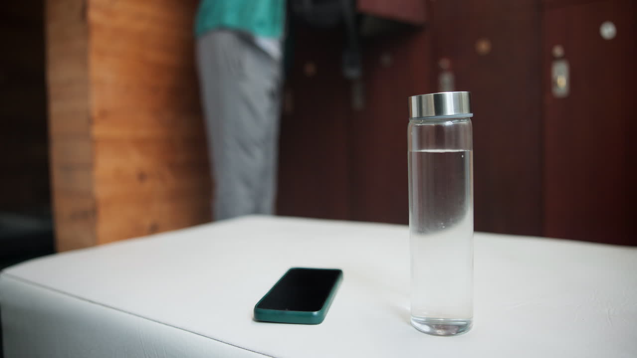 Locker room with water bottle and phone