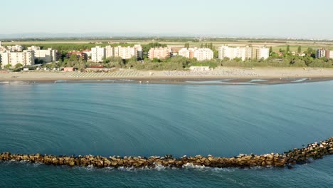 Aerial-shot-of-sandy-beach-with-umbrellas-and-gazebos