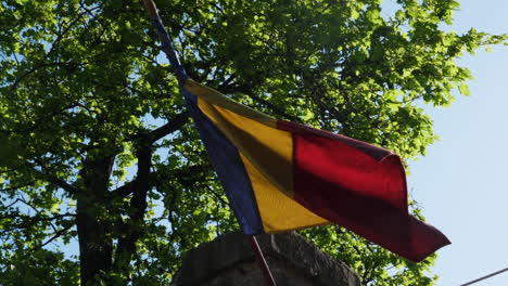 romanian flag waving on a sunny sky