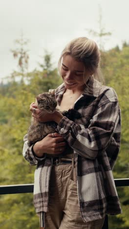 woman holding cat outdoors