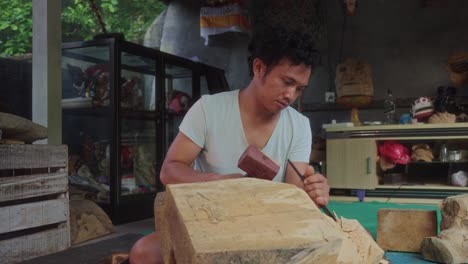 the craftsmanship of a local ubud, balinese artist, masterfully sculpting barong masks from wood, embodying the mythical spirit of bali's traditional dance