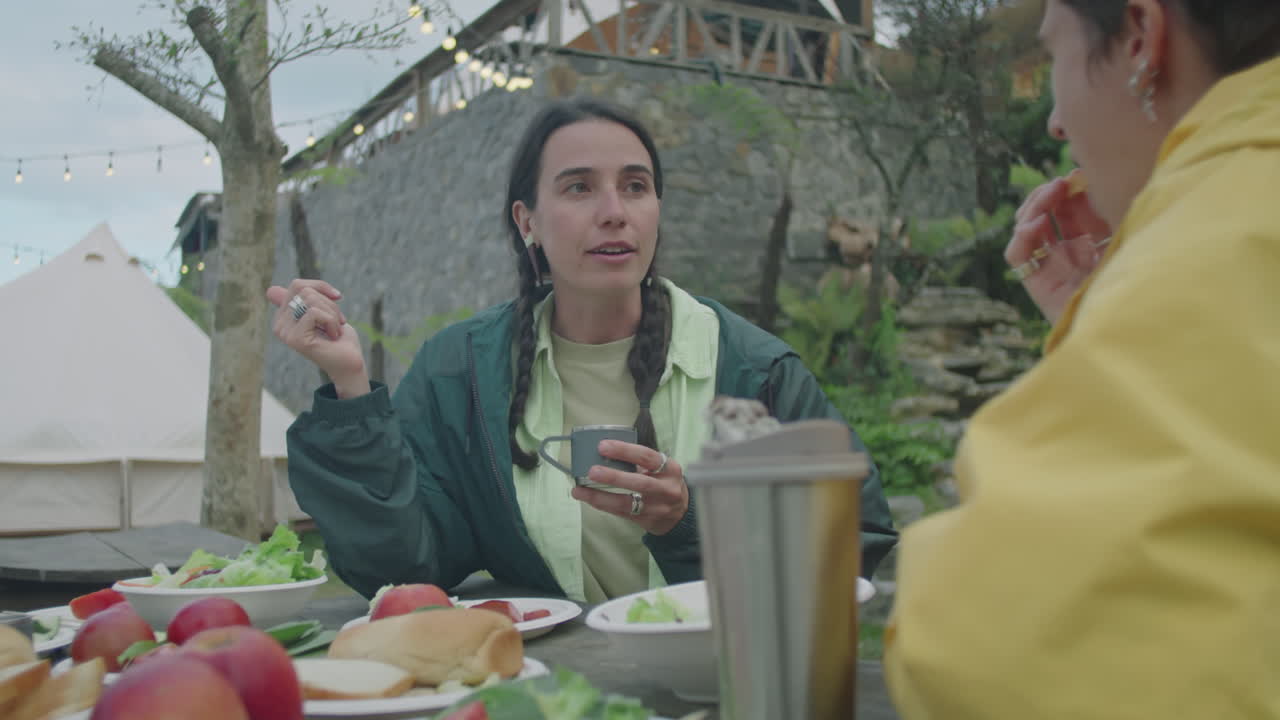 Girl Having Tea and Chatting with Friends on Dinner at Glampsite