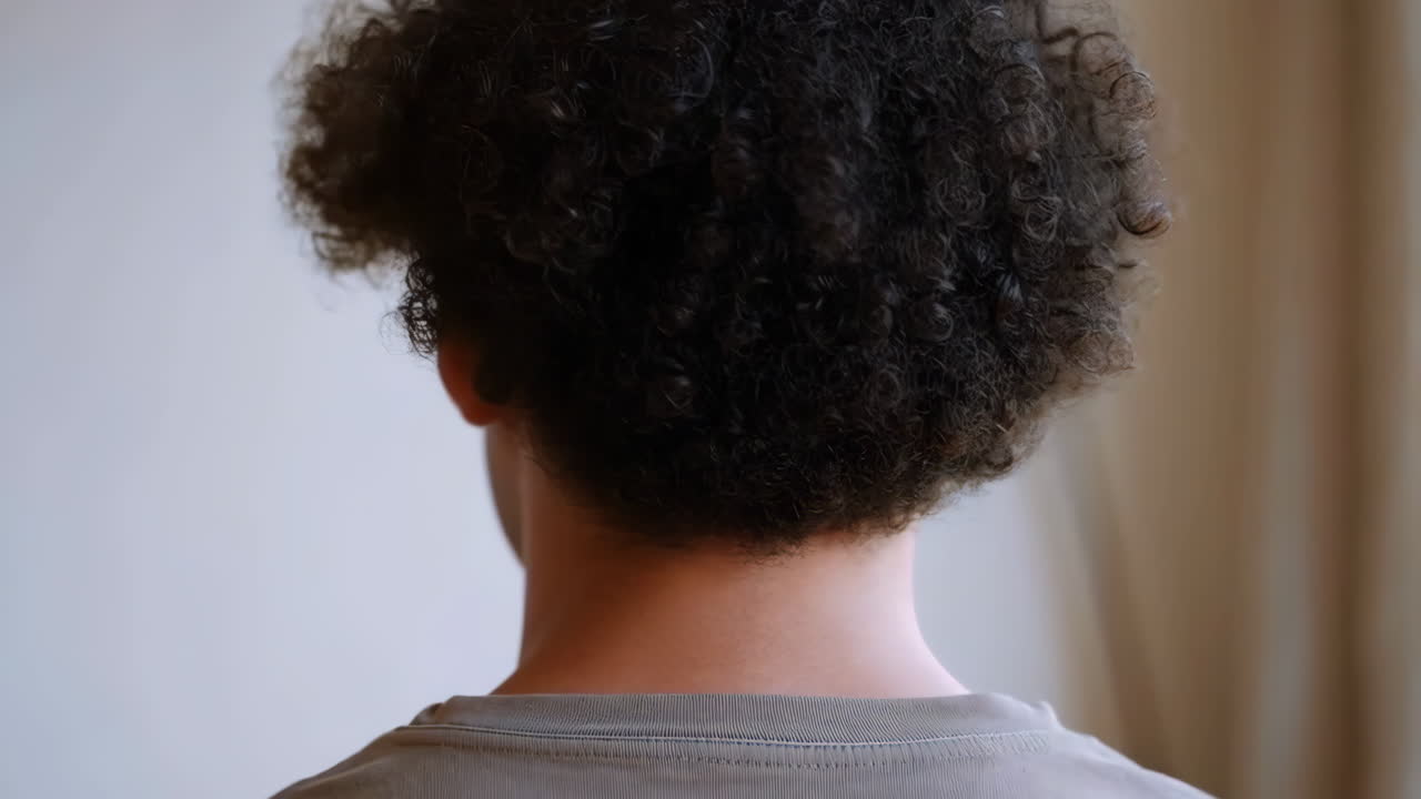 Rear view of a person with curly hair