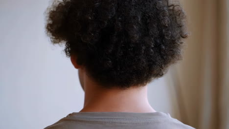rear view of a person with curly hair